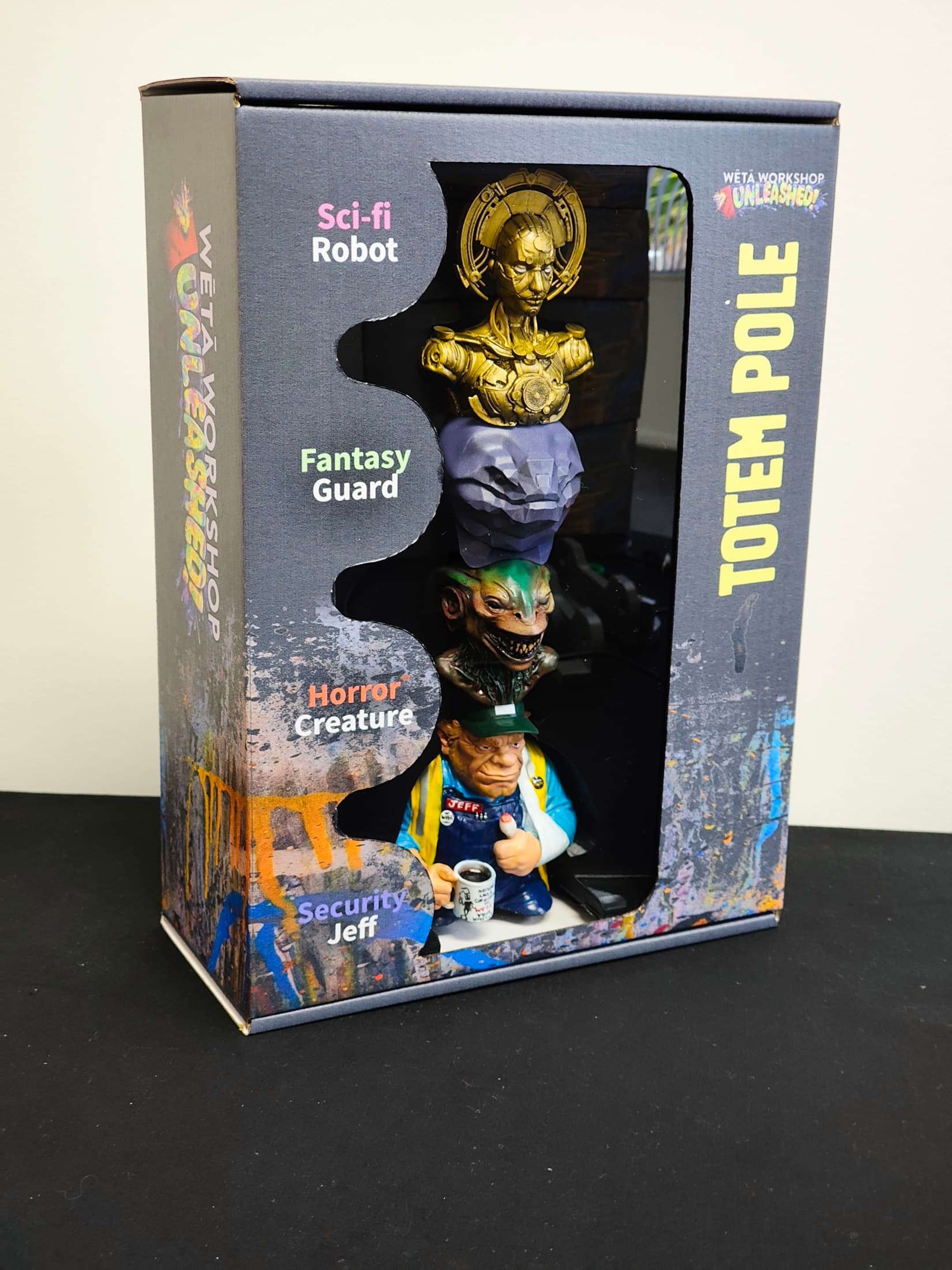 Front of the Wētā Workshop Unleashed Totem Pole box, the four collectible busts visible through the die-cut window
