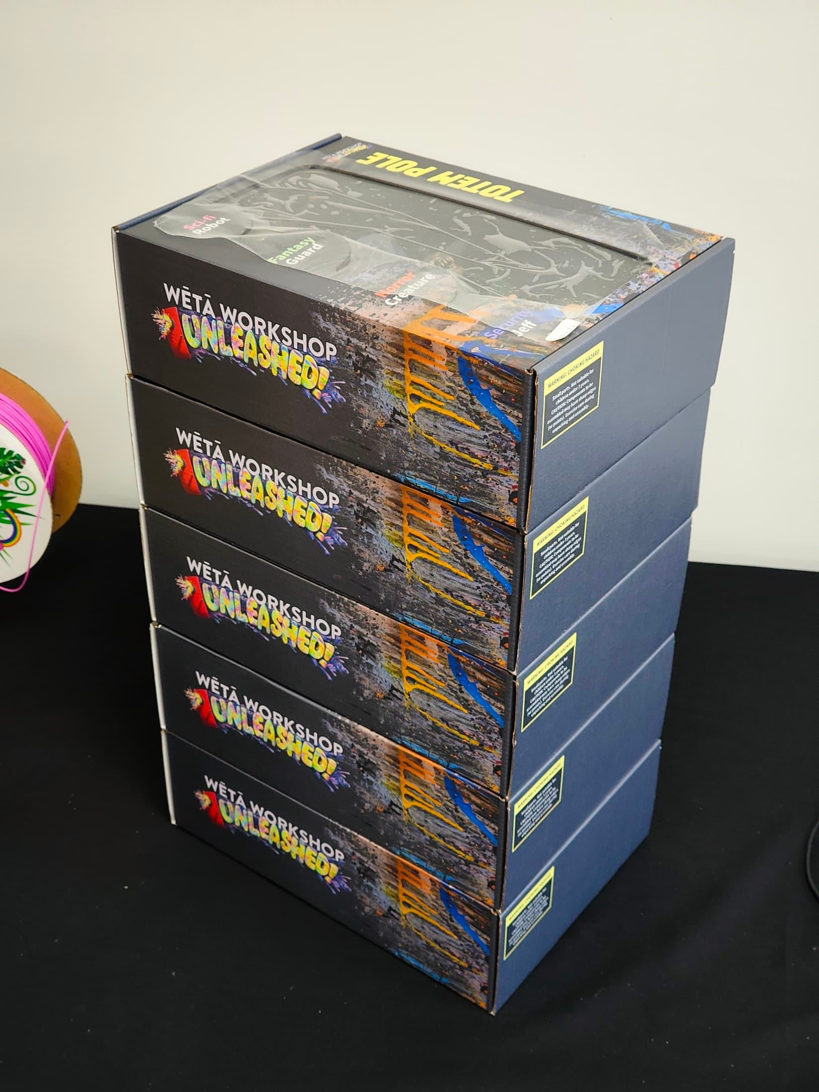 A stack of the finished boxes showing the printed lids and side panels